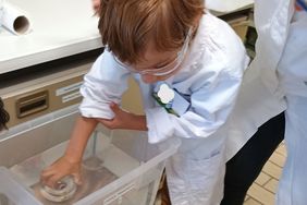 Kindergarten children experiment in the laboratories at the Institute of Chemistry