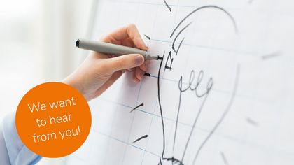 close up of hand drawing light bulb on flip chart Foto Ideas Competition: We want to hear from you!