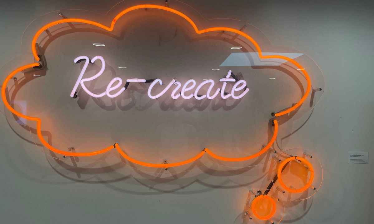 Teaching Across Borders  A neon installation with the word "Re-create".