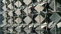 Lateral close-up of the metal plates, which are turned in different directions.