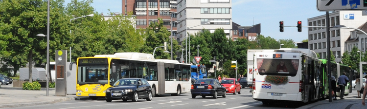 Public transport in Oldenburg Buses and cars on a road in Oldenburg