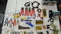 Another wimmelpicture: Pliers, measuring devices, cables and tools lie on a table.