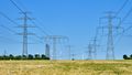 Landscape with power lines and wind turbines on the horizon.