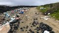 The beach is almost completely buried under plastic pieces of all sizes, including screens, fenders, fishing nets, but also smaller, colorful splinters.