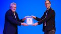 Werner Brinker presents a certificate to Ingo Schoolmann. 