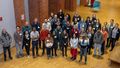 Group photo of researchers and university staff in the foyer of the library on the occasion of the reception for international researchers.