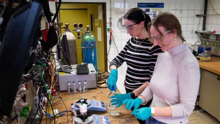 Two young women with safety goggles and hand