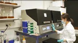 Woman in laboratory using incubator